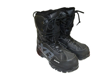 Black snowmobile boots on a white surface.