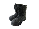 Black snow boots on a white surface.