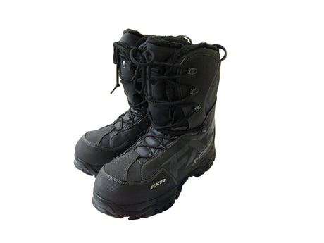 Black snow boots on a white surface.