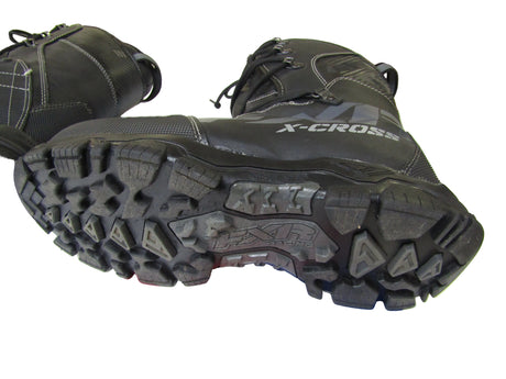 Black X-Cross boots with a focus on the sole, on a white surface.